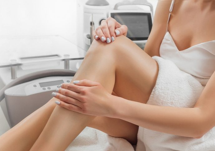 Woman after procedure of laser hair removal for leg. Cosmetology, ionization, diamond procedures.